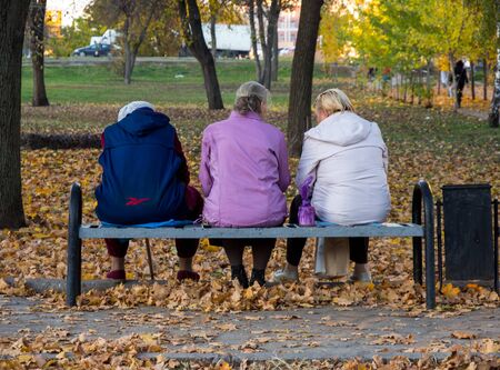 Voronezh, Russia - October 19, 2018: Three older women sit on a park benchのeditorial素材