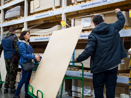 Voronezh, Russia - March 24, 2019: Buyers choose sheets of plywoodのeditorial素材