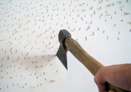 Cutting with the ax on the wall before laying the tileのeditorial素材