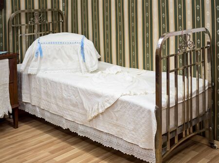 An old metal bed with forged backの写真素材