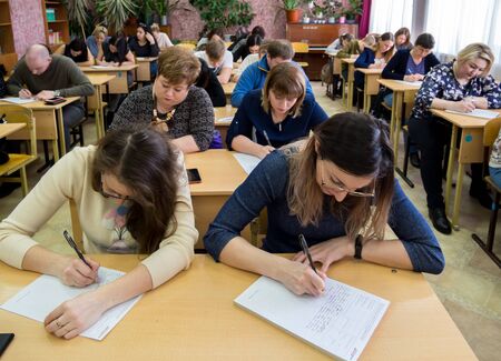 Gadjievo, Russia - April 13, 2019: Adults write tests in school classのeditorial素材