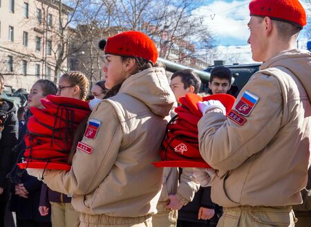 Murmansk, Russia - April 22, 2019: Unarmeys hold piles of uniform beretsのeditorial素材