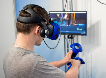 Voronezh, Russia -  June 05, 2019: Man plays a computer game with virtual reality equipment
