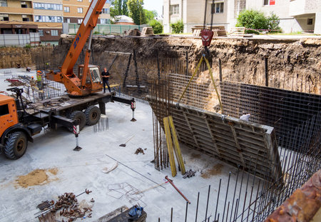 Voronezh, Russia -  June 11, 2019: Installation of formwork in the pit of the future multi-storey...
