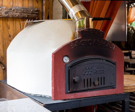 Kabardinka, Russia - August 04, 2019: Culinary stone stove with woodのeditorial素材