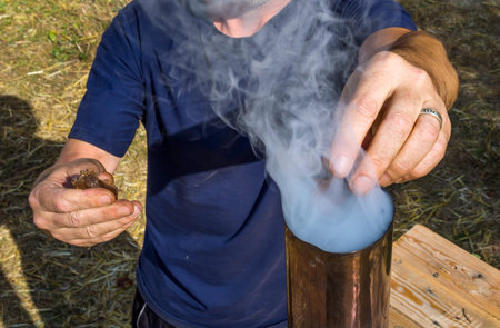Kindling an old samovar through a pipeの写真素材