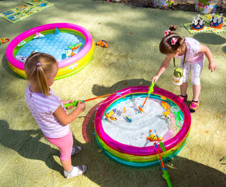 Voronezh, Russia - September 5, 2019: Girls play fishing in a city parkのeditorial素材