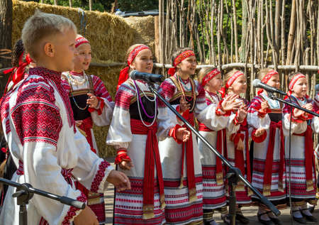 Voronezh, Russia - September 05, 2019: Children sing folk songs in national costumes.のeditorial素材