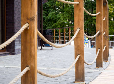 Railing in the form of wooden posts with tensioned ropesの写真素材