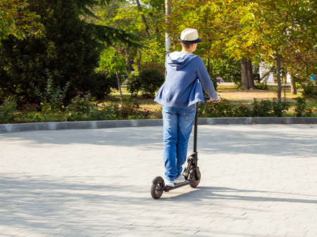 Sevastopol, Crimea - September 19, 2020: Teenager rides a scooter on paving stonesのeditorial素材