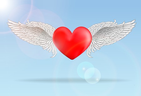 Realistic red flaying heart with white wings in bright sunny dayの写真素材