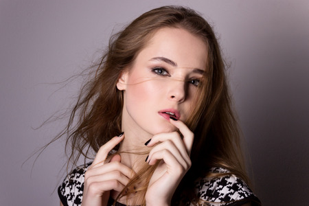 Shooting model testing of a young pretty girl  Professional model posing in the Studio on a black backgroundの写真素材