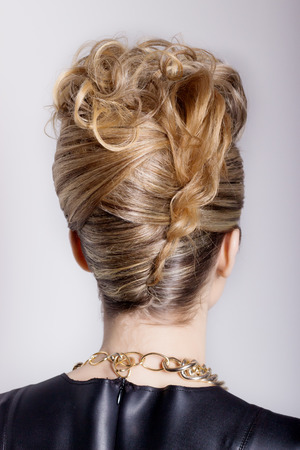Beautiful woman with evening salon hairdo. Complicated hairstyle for partyの写真素材