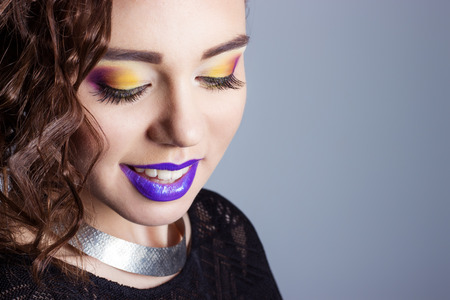 fashion beauty shot of a beautiful young sexy girls with bright makeup and purple lips in the Studio on white backgroundの写真素材