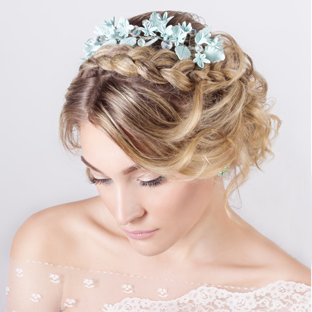 beautiful young sexy elegant sweet girl in the image of a bride with hair and flowers in her hair , delicate wedding makeupの写真素材