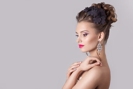fashion portrait of a beautiful attractive girl with a gentle elegant evening wedding hairstyles...
