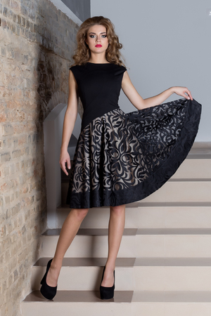 beautiful sexy elegant woman with bright makeup in an evening dress for the event, the New Year, fashion shoot for a clothing catalogの写真素材