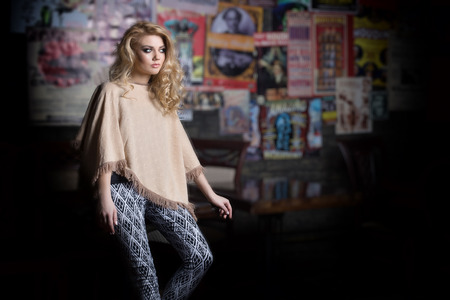 fashion shot of a beautiful sexy girl in fashionable clothes for the catalog with a bright evening make-up in the studio, demonstration of clothes a girlの写真素材