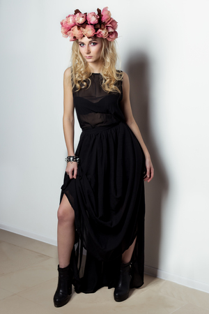 Fashion shot of a beautiful sexy woman with a graceful figure, blond hair with a wreath on his head. Studio shot.の写真素材