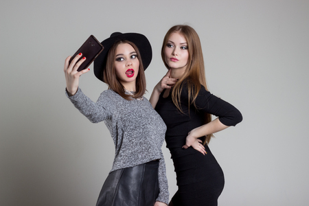 beautiful funny naughty girlfriend relieve themselves on the phone having fun fooling around in the studioの写真素材