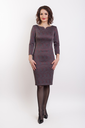 beautiful fashionable sexy girl in a dress for a catalog shoot on a white backgroundの写真素材