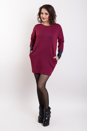 beautiful fashionable sexy girl in a dress for a catalog shoot on a white backgroundの写真素材