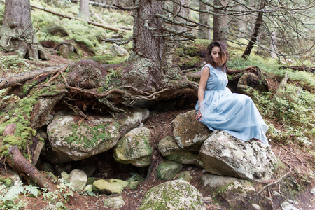 beautiful sweet girl bride in her wedding dress light air in the mountains near the lake, a beautiful landscape of mountainsの写真素材