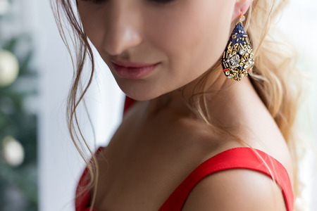 beautiful cute attractive girl in festive evening jewelry jewelryの写真素材