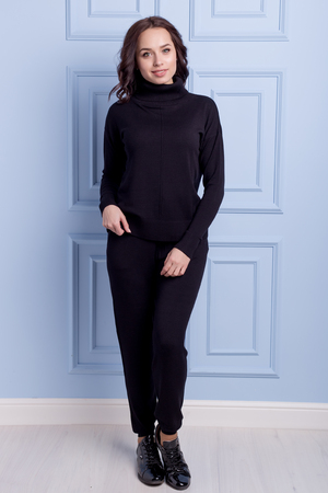 beautiful cute girl with a smile demonstrates knitted clothesの写真素材