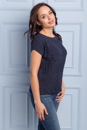 beautiful cute girl with a smile demonstrates knitted clothesの写真素材