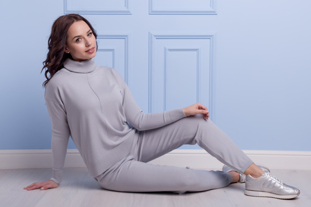 beautiful cute girl with a smile demonstrates knitted clothesの写真素材