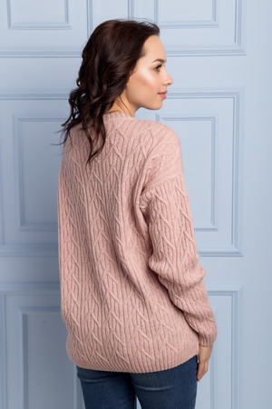 beautiful cute girl with a smile demonstrates knitted clothesの写真素材
