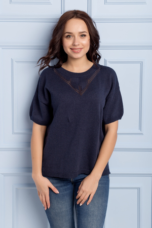 beautiful cute girl with a smile demonstrates knitted clothesの写真素材