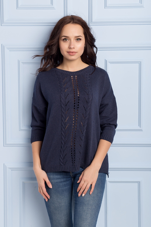 beautiful cute girl with a smile demonstrates knitted clothesの写真素材