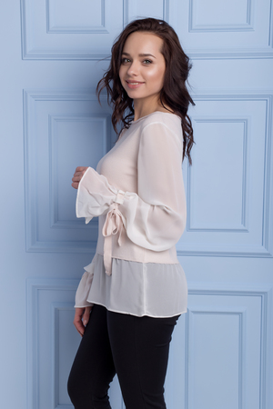 beautiful cute girl with a smile demonstrates knitted clothesの写真素材