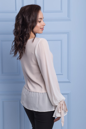 beautiful cute girl with a smile demonstrates knitted clothesの写真素材