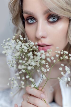 beautiful sweet girl with a large bouquet of flowers for the holidayの写真素材
