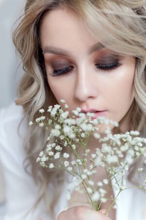 beautiful sweet girl with a large bouquet of flowers for the holidayの写真素材