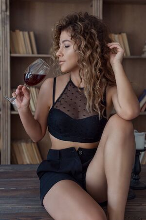 beautiful lovely girl with spots Vitiligo in her arms with a glass of wineの写真素材