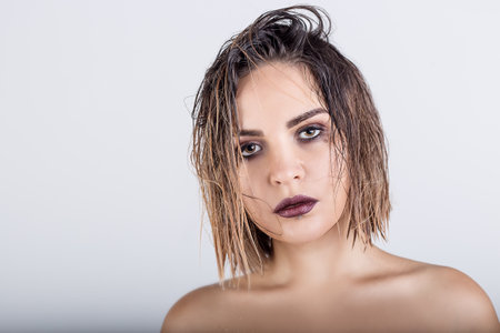 beautiful girl with wet hair on a white backgroundの写真素材