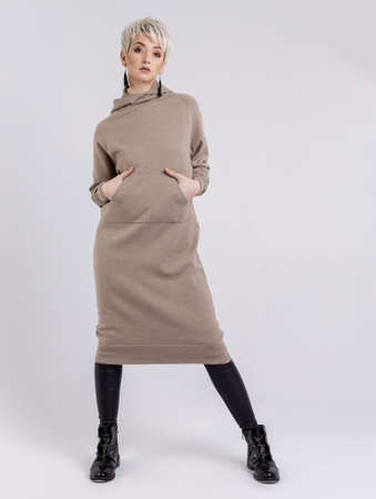 knitted clothes on show on the girl in the studio on a white backgroundの写真素材