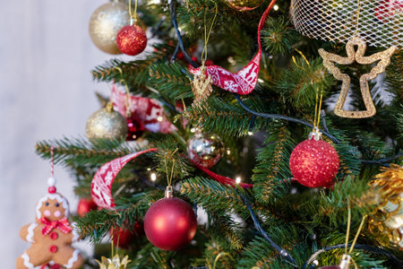 beautiful green christmas tree decoration with toys and ribbonsの写真素材