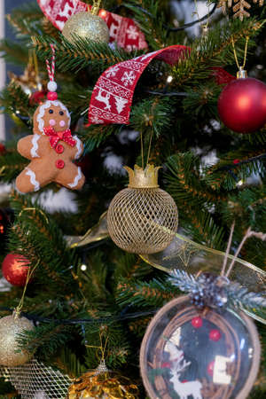 beautiful green christmas tree decoration with toys and ribbonsの写真素材