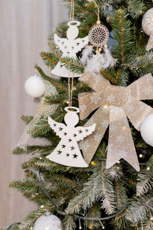beautiful green christmas tree decoration with toys and ribbonsの写真素材