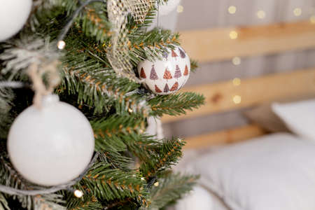 beautiful green christmas tree decoration with toys and ribbonsの写真素材