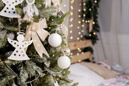 beautiful green christmas tree decoration with toys and ribbonsの写真素材