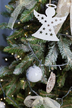 beautiful green christmas tree decoration with toys and ribbonsの写真素材