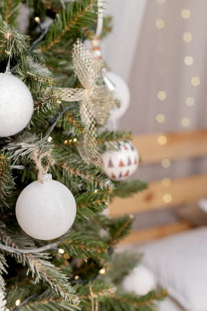 beautiful green christmas tree decoration with toys and ribbonsの写真素材