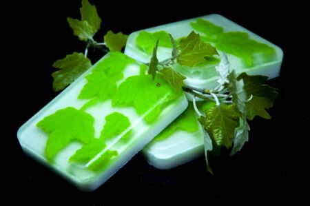 natural soap green leaves. beautiful soap.soap on a black background.の写真素材