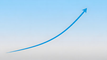 Blue arrow pointing up on blue sky background. Success and growth concept.の素材